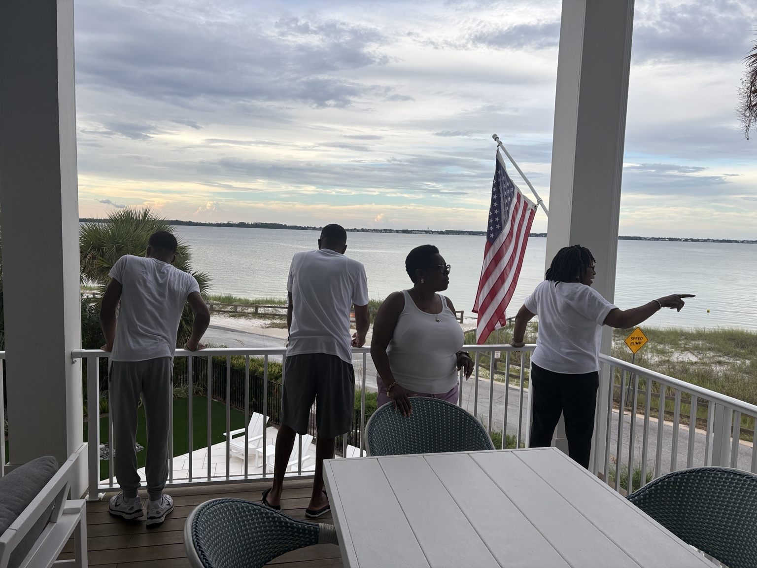 Family looking across the water from the beach-house porch