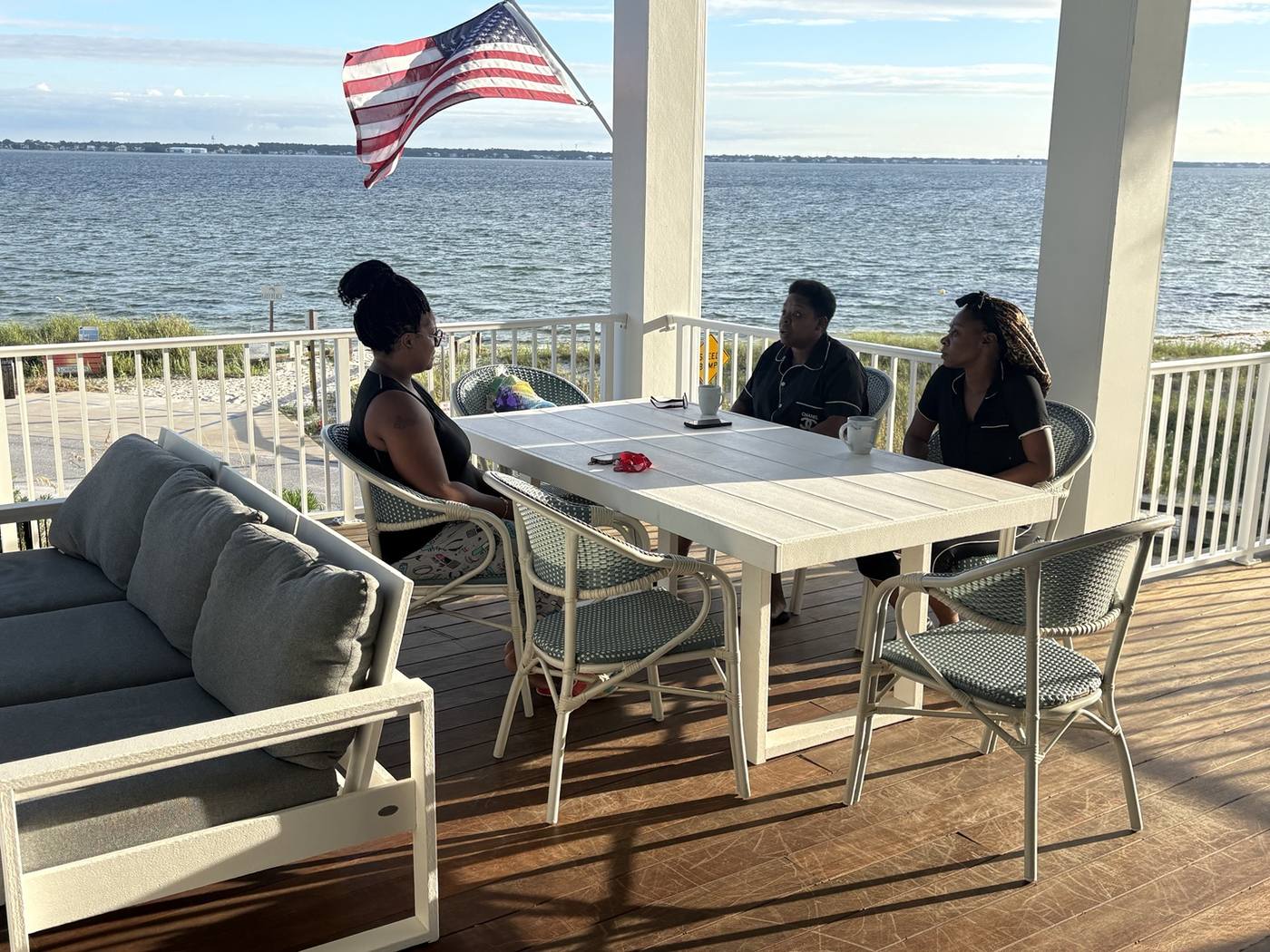 Family talking on the waterfront porch