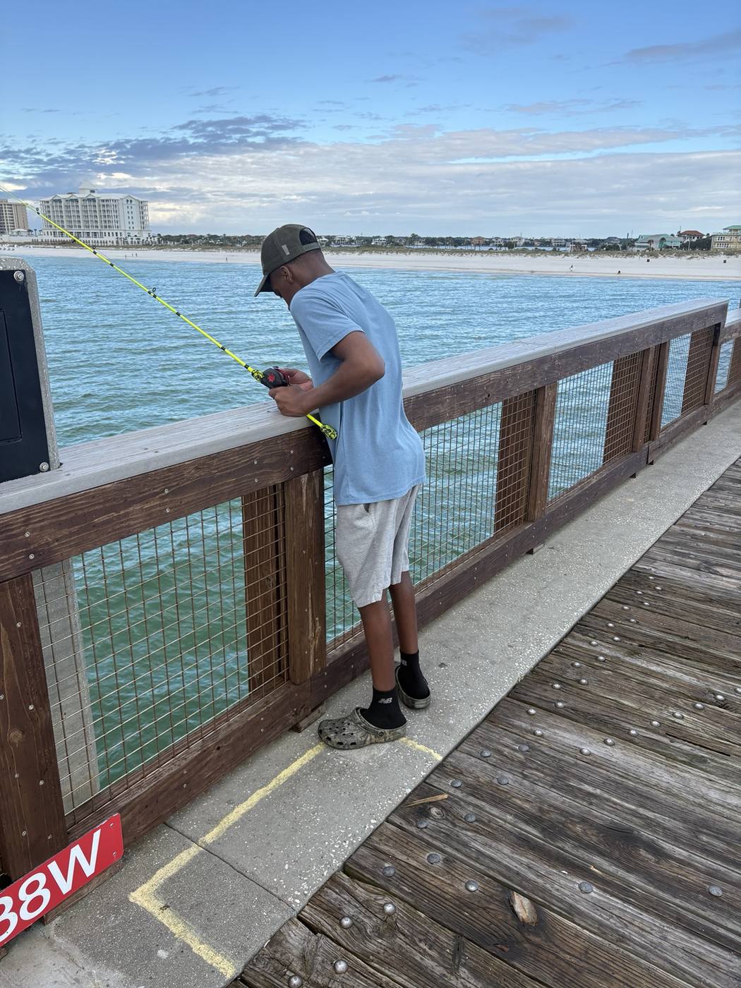 Young family member fishing from the pier