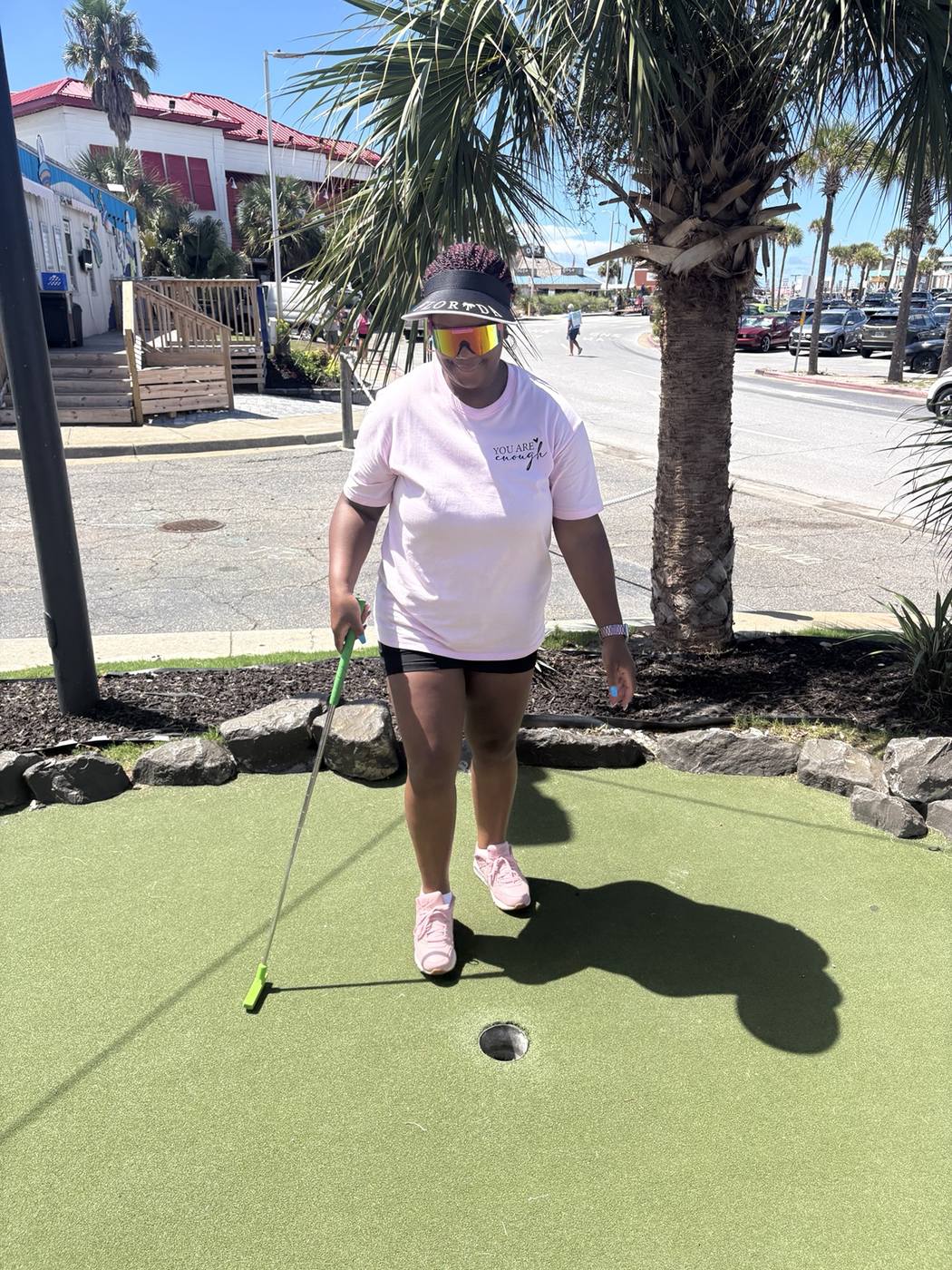 Family member enjoying miniature golf during reunion weekend