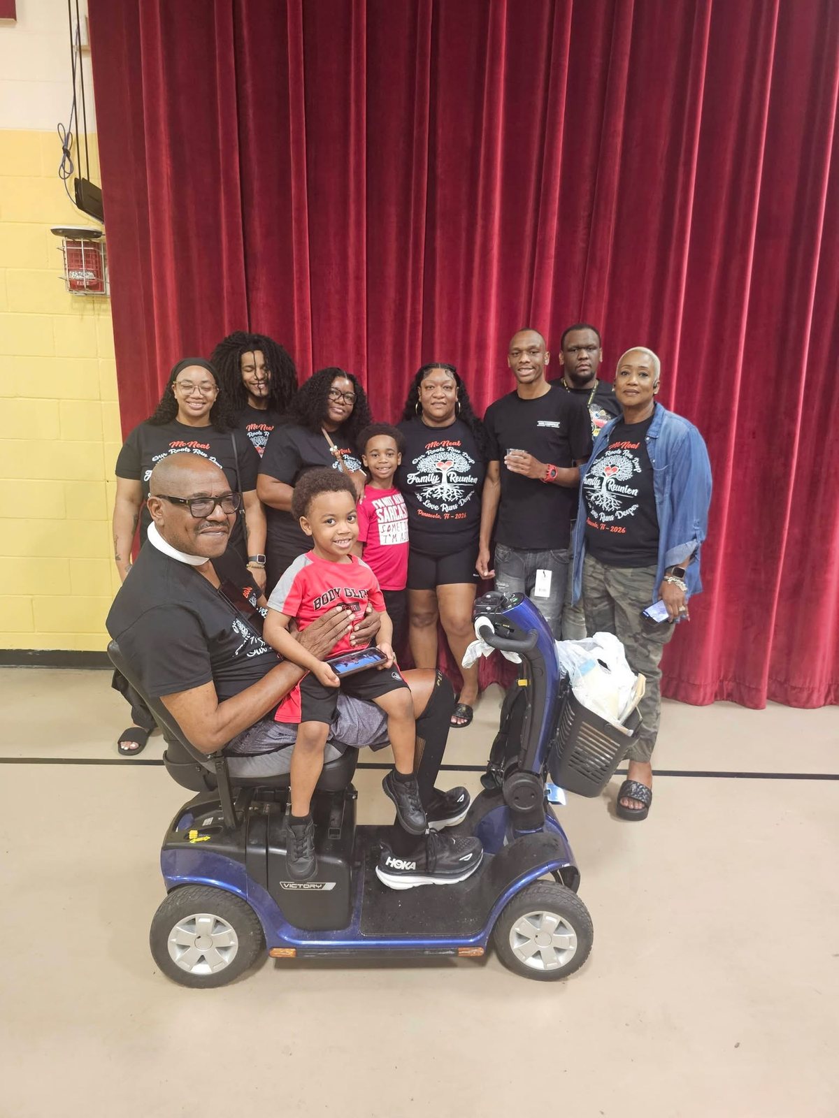 Family group gathered around an elder at the reunion